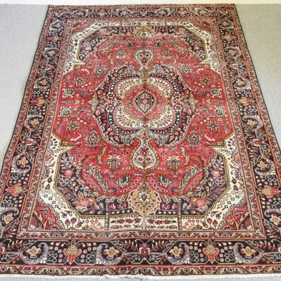 Lot 205 - A Persian Tabriz carpet, with a large central...