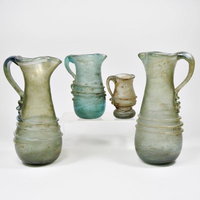 Lot 9 - An iridescent green glass jug, probably late...