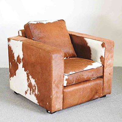 Lot 266 - An Art Deco style armchair, upholstered in cow...