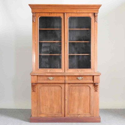 Lot 216 - A Victorian walnut bookcase, with cupboards...