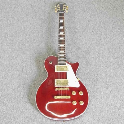 Lot 318 - A red Johnson Les Paul electric guitar