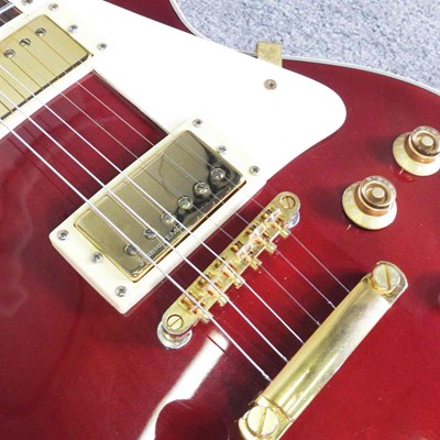 Lot 318 - A red Johnson Les Paul electric guitar