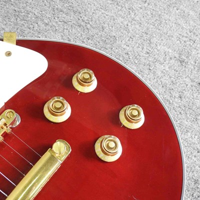 Lot 318 - A red Johnson Les Paul electric guitar