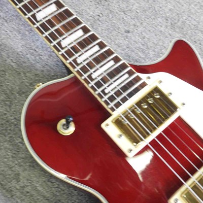 Lot 318 - A red Johnson Les Paul electric guitar