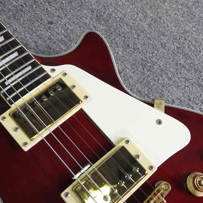 Lot 318 - A red Johnson Les Paul electric guitar