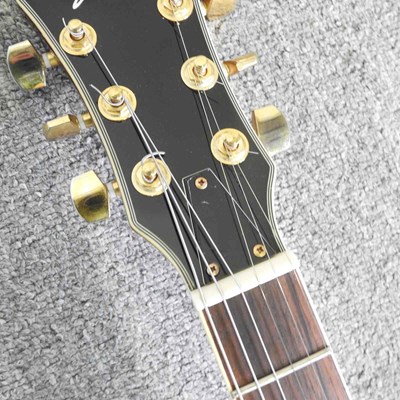 Lot 318 - A red Johnson Les Paul electric guitar