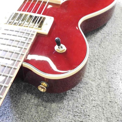 Lot 318 - A red Johnson Les Paul electric guitar