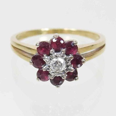 Lot 233 - An 18 carat gold ruby and diamond cluster ring,...