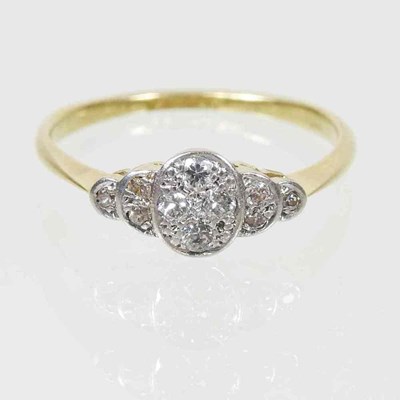 Lot 20 - An 18 carat gold platinum set diamond cluster...