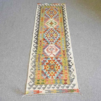 Lot 329 - A chobi kilim runner, with a row of central...