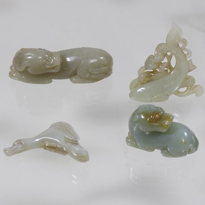 Lot 97 - An oriental jade coloured hardstone carving of a recumbent dog