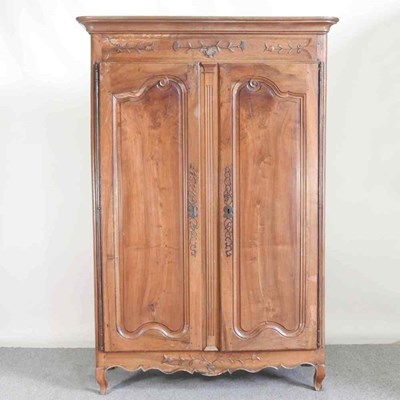 Lot 553 - A 19th century French fruitwood armoire, with...