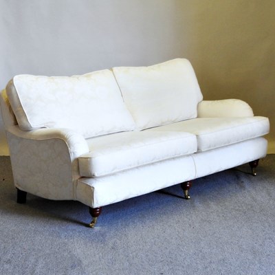 Lot 302 - A cream damask upholstered sofa, on turned...