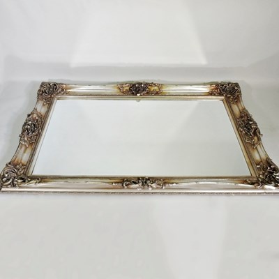 Lot 497 - A large modern wall mirror, with a silver...