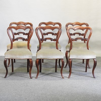 Lot 556 - A set of six Victorian carved rosewood dining chairs