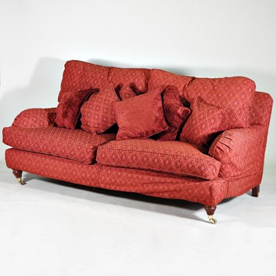 Lot 589 - A modern red upholstered two seater sofa, with...