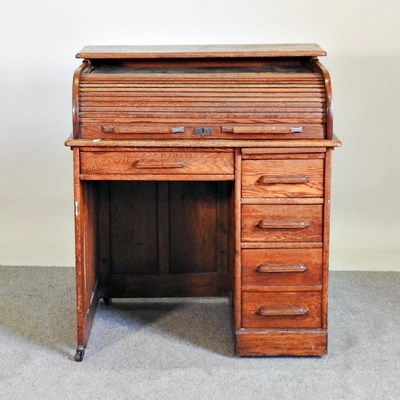 Lot 445 - A 1920's oak tambour top single pedestal desk