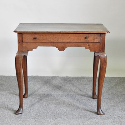 Lot 534 - An 18th century oak lowboy, with a single...