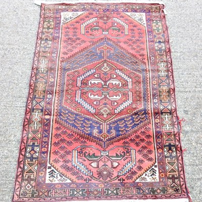 Lot 98 - A Persian rug, with hooked designs, within...