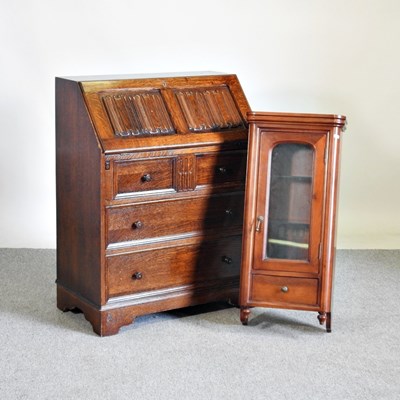 Lot 165 - An oak bureau, with linenfold panels, together...