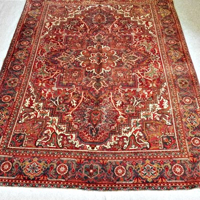 Lot 305 - A Persian heriz carpet, with all over designs,...