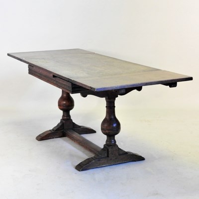 Lot 375 - An 18th century style oak draw leaf dining...