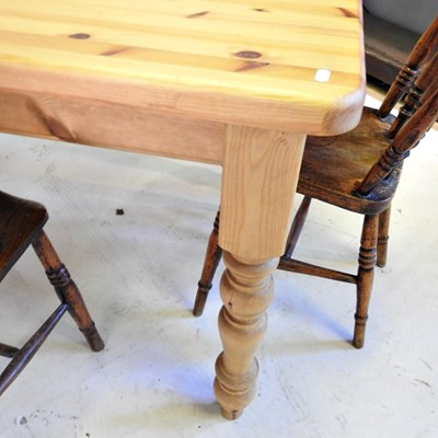 Lot 498 - A pine kitchen table, together with three...