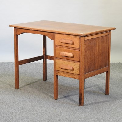 Lot 492 - A mid 20th century light oak desk