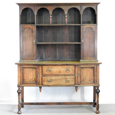 Lot 407 - A 1920's Jacobean style oak dresser, on turned...