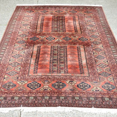 Lot 252 - A large Persian woollen carpet, having two...