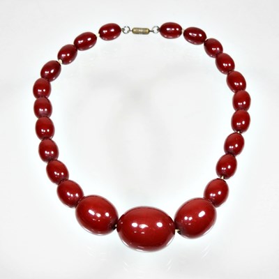 Lot 35 - A cherry bakelite amber single strand...