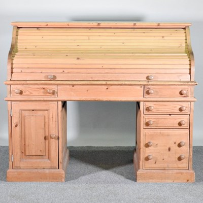 Lot 238 - A large pine tambour top pedestal desk, on a...