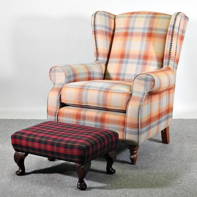 Lot 234 - A modern tartan upholstered wing armchair, on...