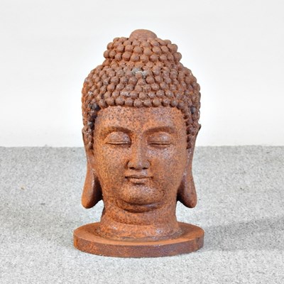 Lot 518 - A cast metal head of a Buddha, 32cm high