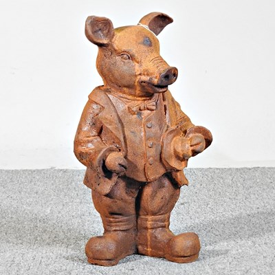 Lot 500 - A rusted garden statue of Mr Pig, 43cm high