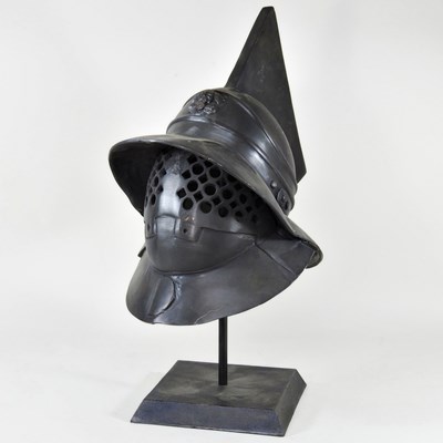 Lot 104 - An antique style military helmet, on a metal...