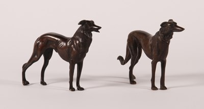 Lot 161 - A pair of bronze models of dogs, each shown in...