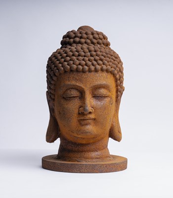 Lot 456 - A rusted cast iron Buddha head, h. 34cm