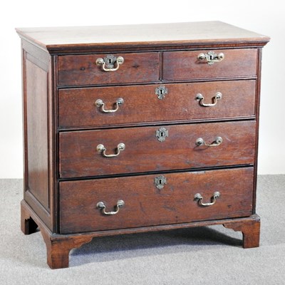 Lot 135 - A George III oak chest of drawers, on bracket...