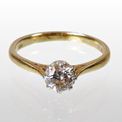 Lot 153 - An 18 carat gold and platinum set solitaire...