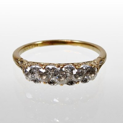 Lot 136 - An 18 carat gold five stone diamond ring, with...