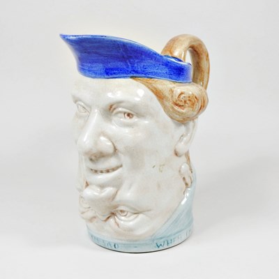 Lot 13 - A majolica character jug, probably...