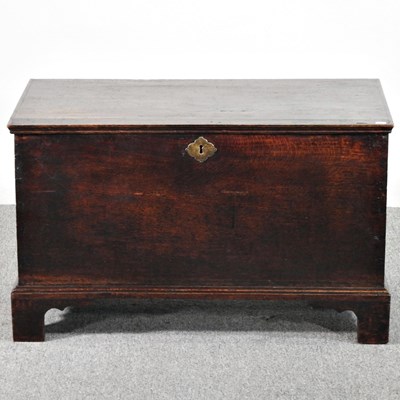 Lot 231 - An 18th century oak chest, with a hinged lid,...