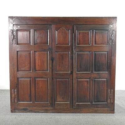 Lot 183 - An 18th century oak part cabinet, enclosed by...