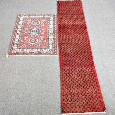 Lot 519 - A Persian runner, on a red ground, 256 x 56cm...