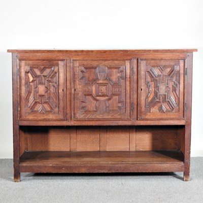 Lot 552 - An early 20th century carved oak sideboard,...