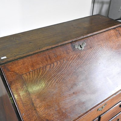 Lot 64 - A George III mahogany bureau, on bracket feet