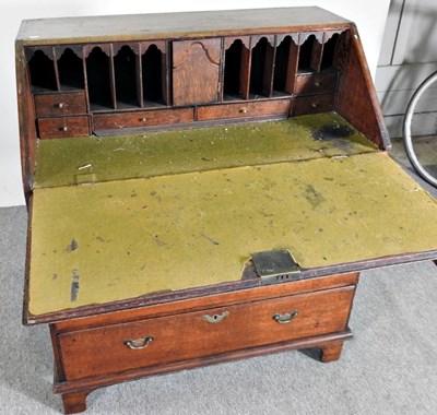 Lot 64 - A George III mahogany bureau, on bracket feet