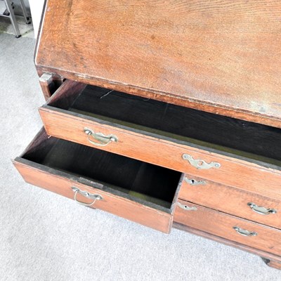 Lot 64 - A George III mahogany bureau, on bracket feet