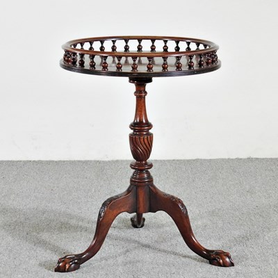 Lot 93 - A reproduction occasional table, with a...